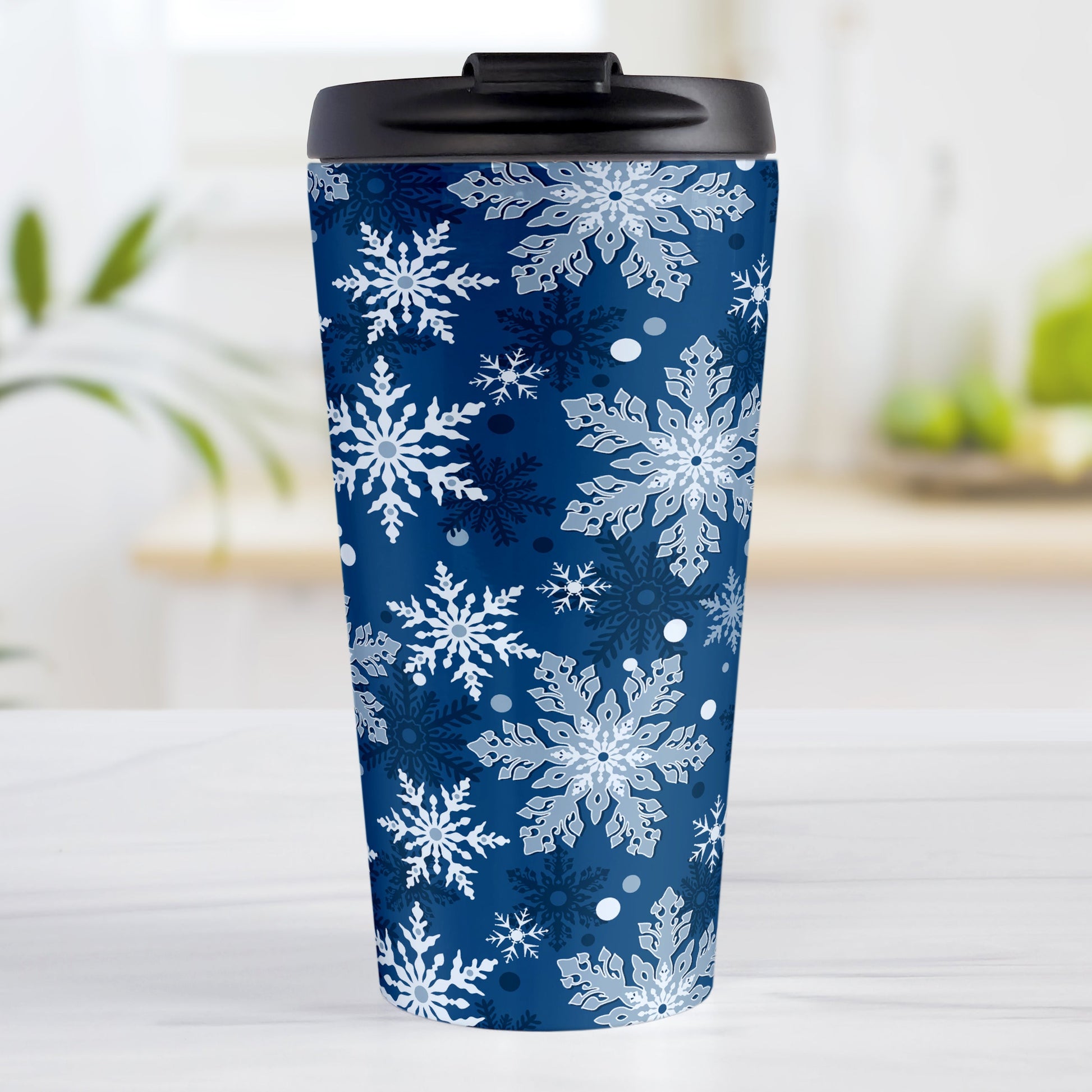 Classic Blue Snowflake Pattern Winter Travel Mug (15oz) at Amy's Coffee Mugs. A stainless steel insulated travel mug designed with a pattern of different shades of blue snowflakes over a classic blue background color that wraps around the travel mug.