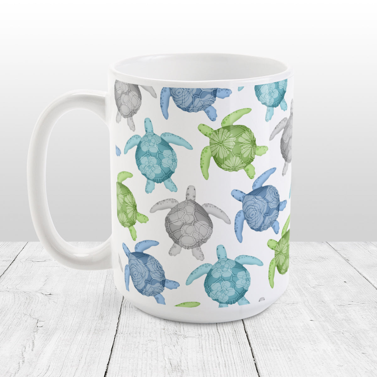 Cool Sea Turtles Pattern Mug (15oz) at Amy's Coffee Mugs. A ceramic mug with a pattern of sea turtles in a cool color palette of blue, green, turquoise and gray that wraps around the mug to the handle. Each cool colored sea turtle has a different floral watermark over its shell.