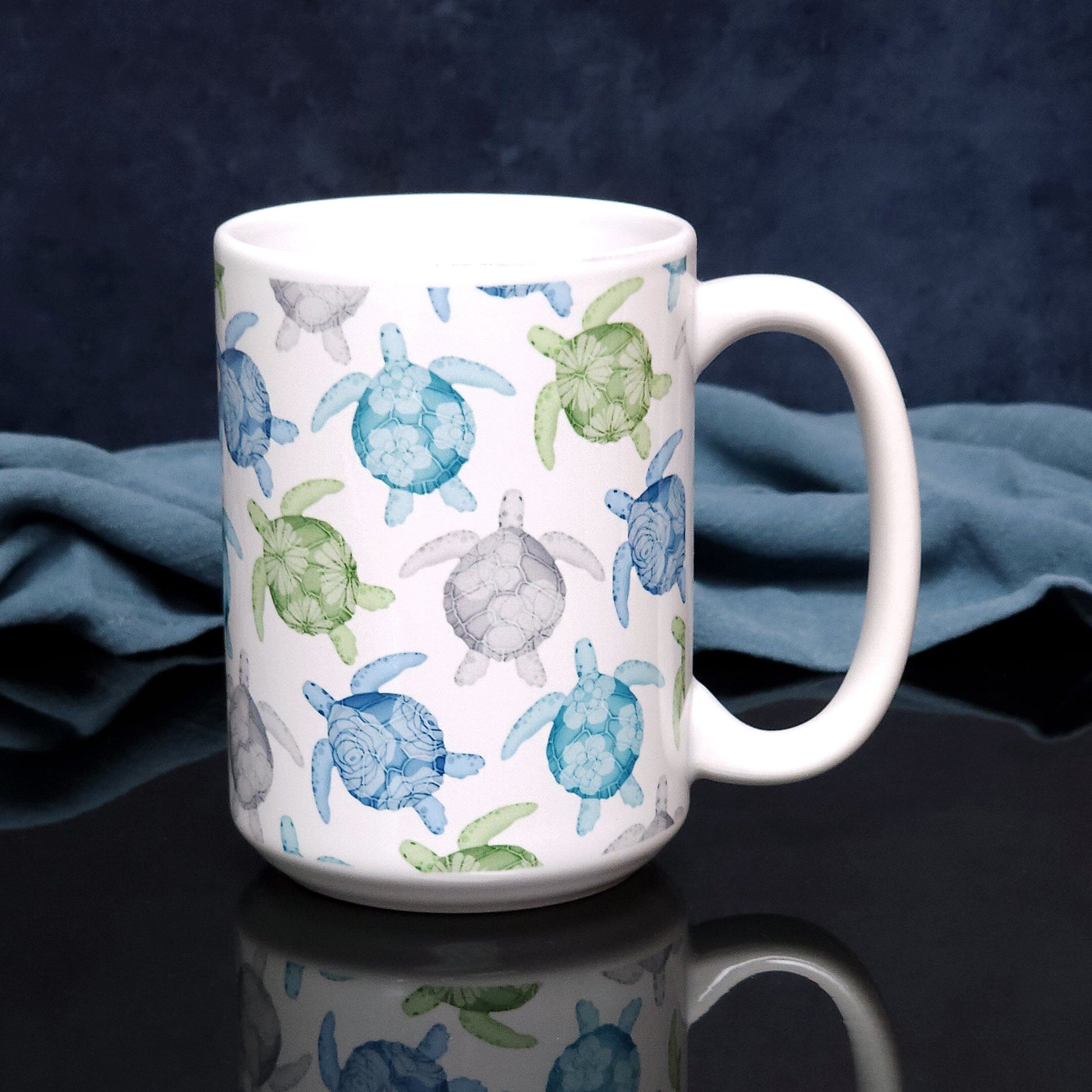 Cool Sea Turtles Pattern Mug (15oz) on a glossy black tabletop with a midnight blue background. 