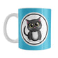 Cute Gray Cat Blue Mug (11oz) at Amy's Coffee Mugs. A ceramic coffee mug designed with an adorable gray cat in a white circle outlined in black and gray on both sides of the mug over a blue background color that wraps around the mug up to the handle.