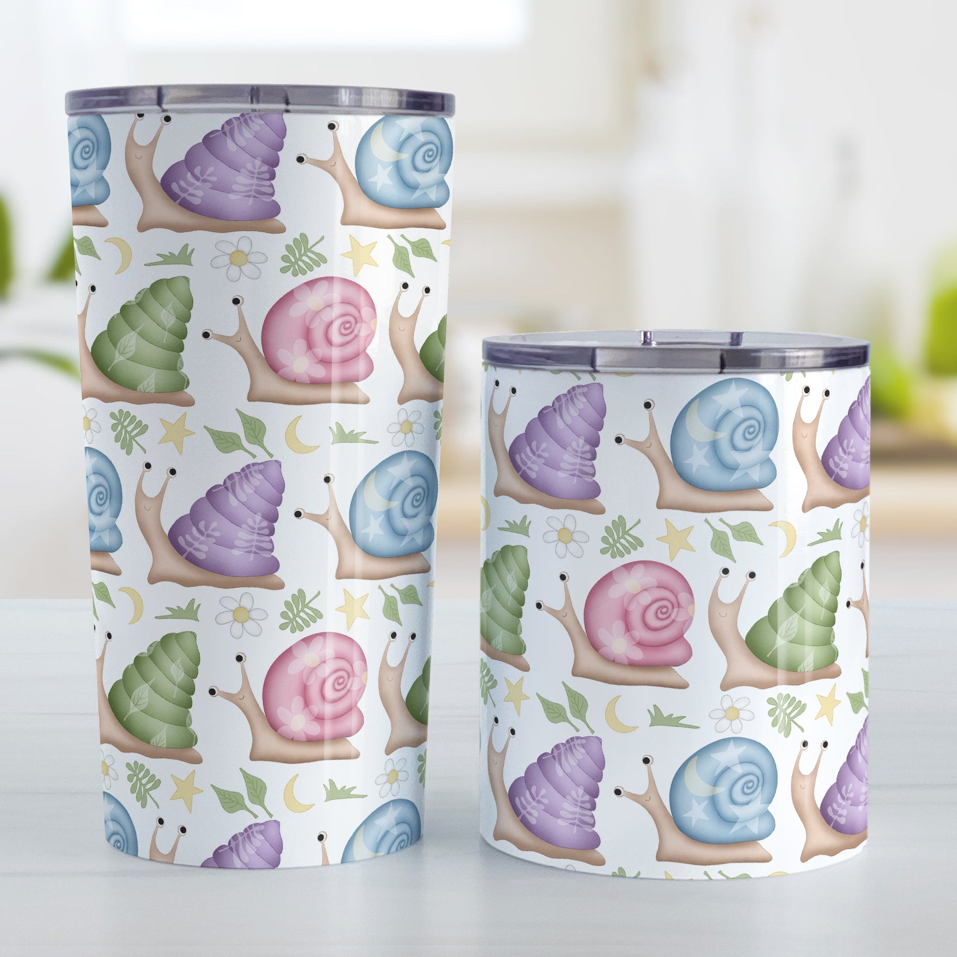 Cute Spring Summer Snails Pattern Tumbler Cup (20oz and 10oz, stainless steel insulated) at Amy's Coffee Mugs. Cute snails tumbler cups with a whimsical pattern of snails with happy faces in rows around the cups with pink, purple, blue, and green shells floral and stars watermarks, with foliage, moons, and stars between the rows. The two sizes of cups are displayed next to each other.