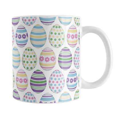 Easter Eggs Mug (11oz) at Amy's Coffee Mugs. A ceramic coffee mug designed with a pattern of Easter eggs decorated with stripes, polka dots, and flowers in fun Easter-inspired colors.