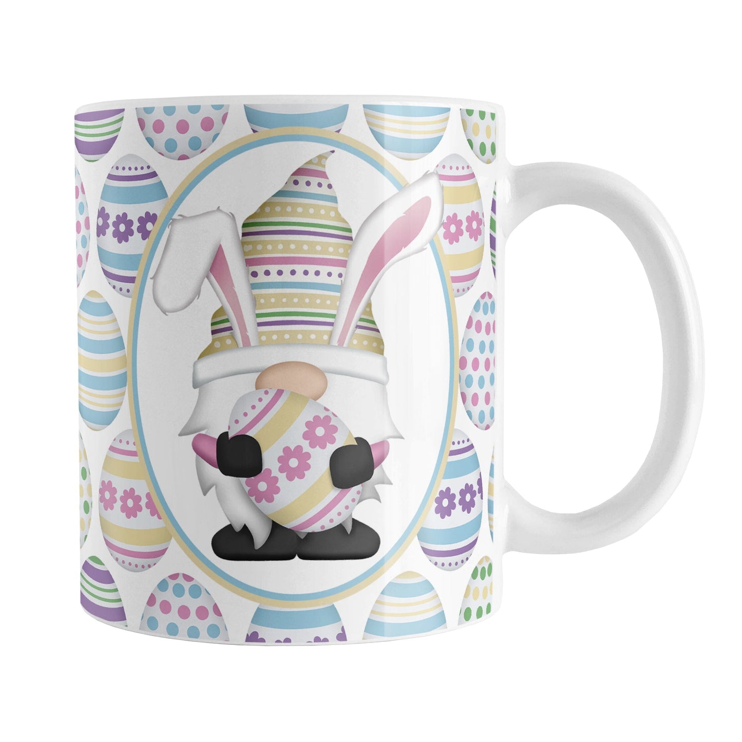 Easter Gnome Eggs Mug (11oz) at Amy's Coffee Mugs. A ceramic coffee mug designed with an illustration of an adorable gnome with bunny ears, holding a large pink and yellow Easter egg, in a white oval on both sides of the mug over a decorated Easter eggs pattern.
