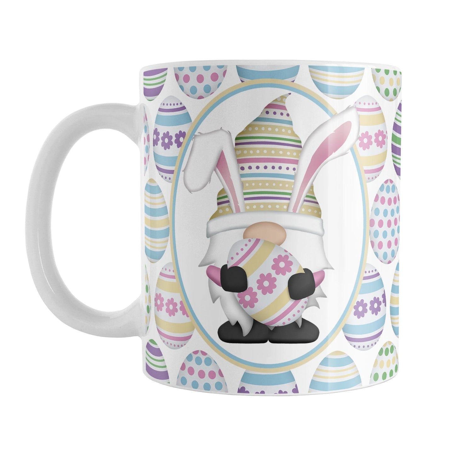 Easter Gnome Eggs Mug (11oz) at Amy's Coffee Mugs. A ceramic coffee mug designed with an illustration of an adorable gnome with bunny ears, holding a large pink and yellow Easter egg, in a white oval on both sides of the mug over a decorated Easter eggs pattern.