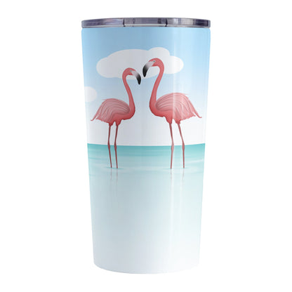 Flamingos in the Water Tumbler Cup (20oz) at Amy's Coffee Mugs. A stainless steel tumbler cup designed with an illustration of two pink flamingos standing in the ocean water, with fresh and clean open water with ripples and a bright blue sky.