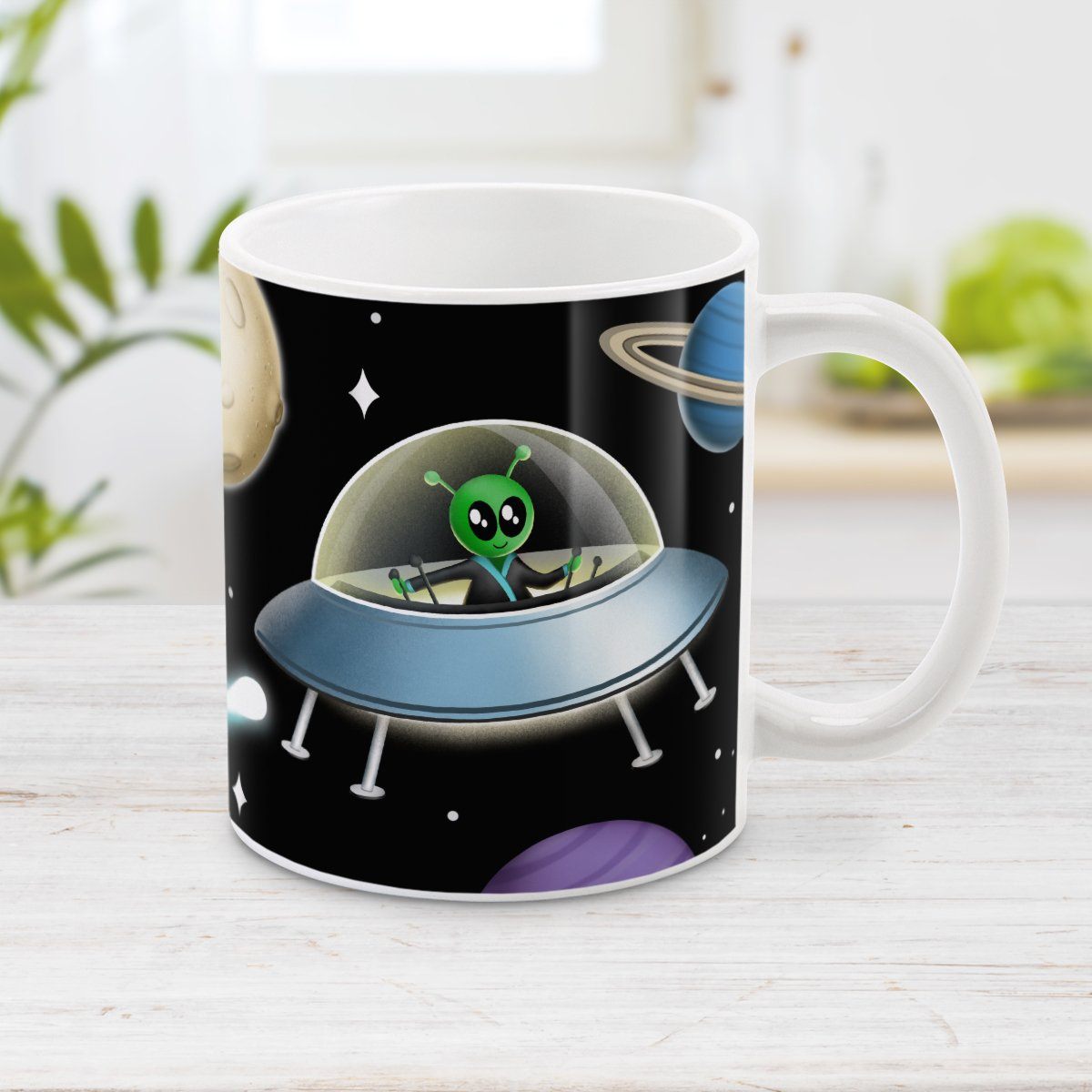 Galaxy Green Alien Spaceship Mug at Amy's Coffee Mugs. A galaxy spaceship mug designed with an illustration of a green alien in a spaceship in a galaxy design with planets, stars, comets, and a moon over a black background.