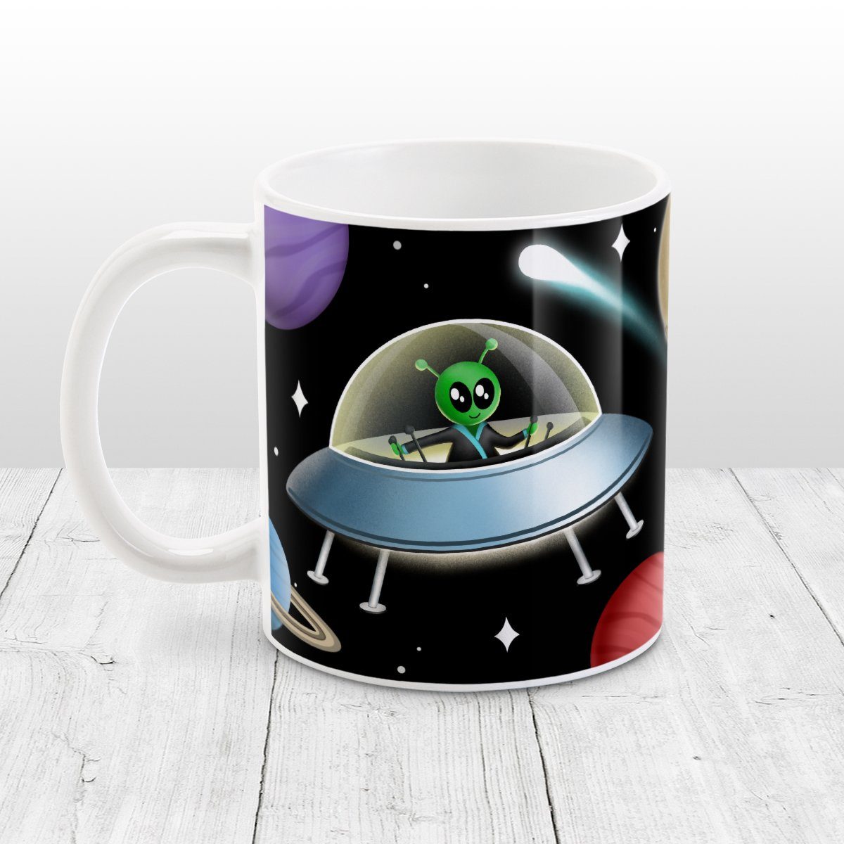 Galaxy Green Alien Spaceship Mug at Amy's Coffee Mugs. A galaxy spaceship mug designed with an illustration of a green alien in a spaceship in a galaxy design with planets, stars, comets, and a moon over a black background.