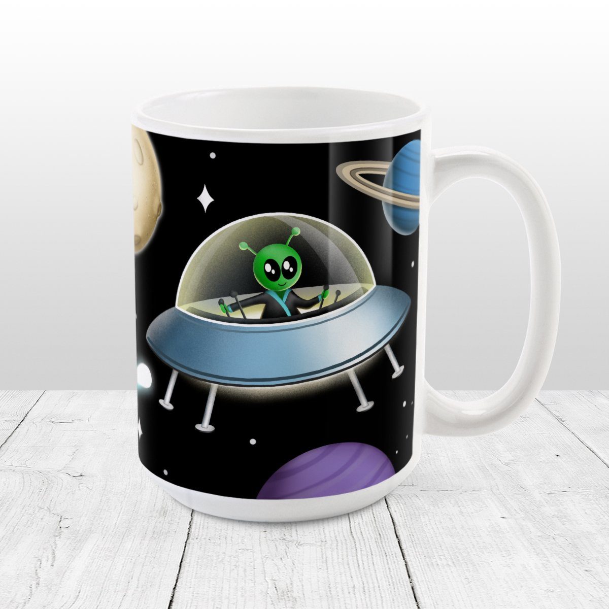 Galaxy Green Alien Spaceship Mug at Amy's Coffee Mugs. A galaxy spaceship mug designed with an illustration of a green alien in a spaceship in a galaxy design with planets, stars, comets, and a moon over a black background.