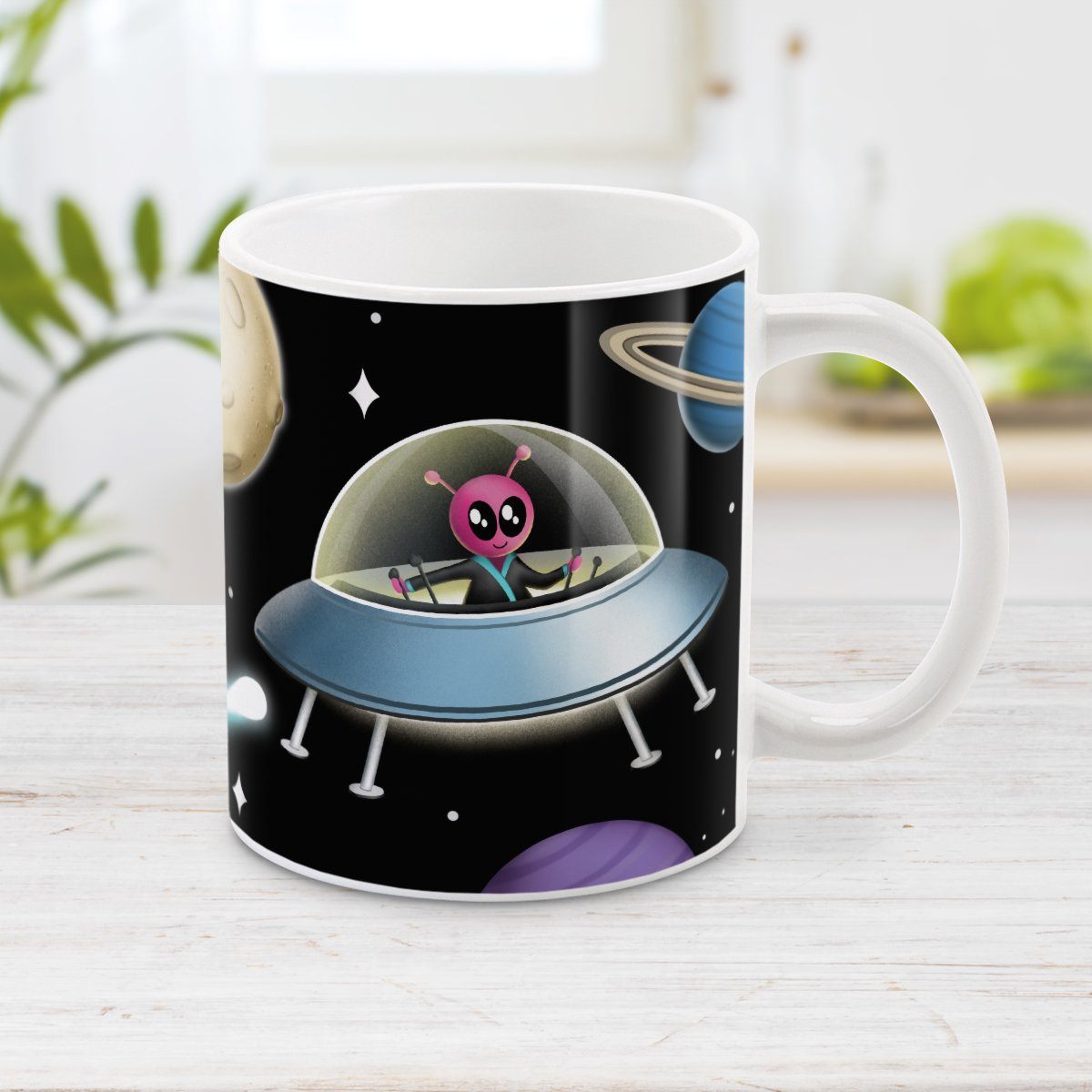 Galaxy Pink Alien Spaceship Mug at Amy's Coffee Mugs. A galaxy spaceship mug designed with an illustration of a pink alien in a spaceship in a galaxy design with planets, stars, comets, and a moon over a black background.