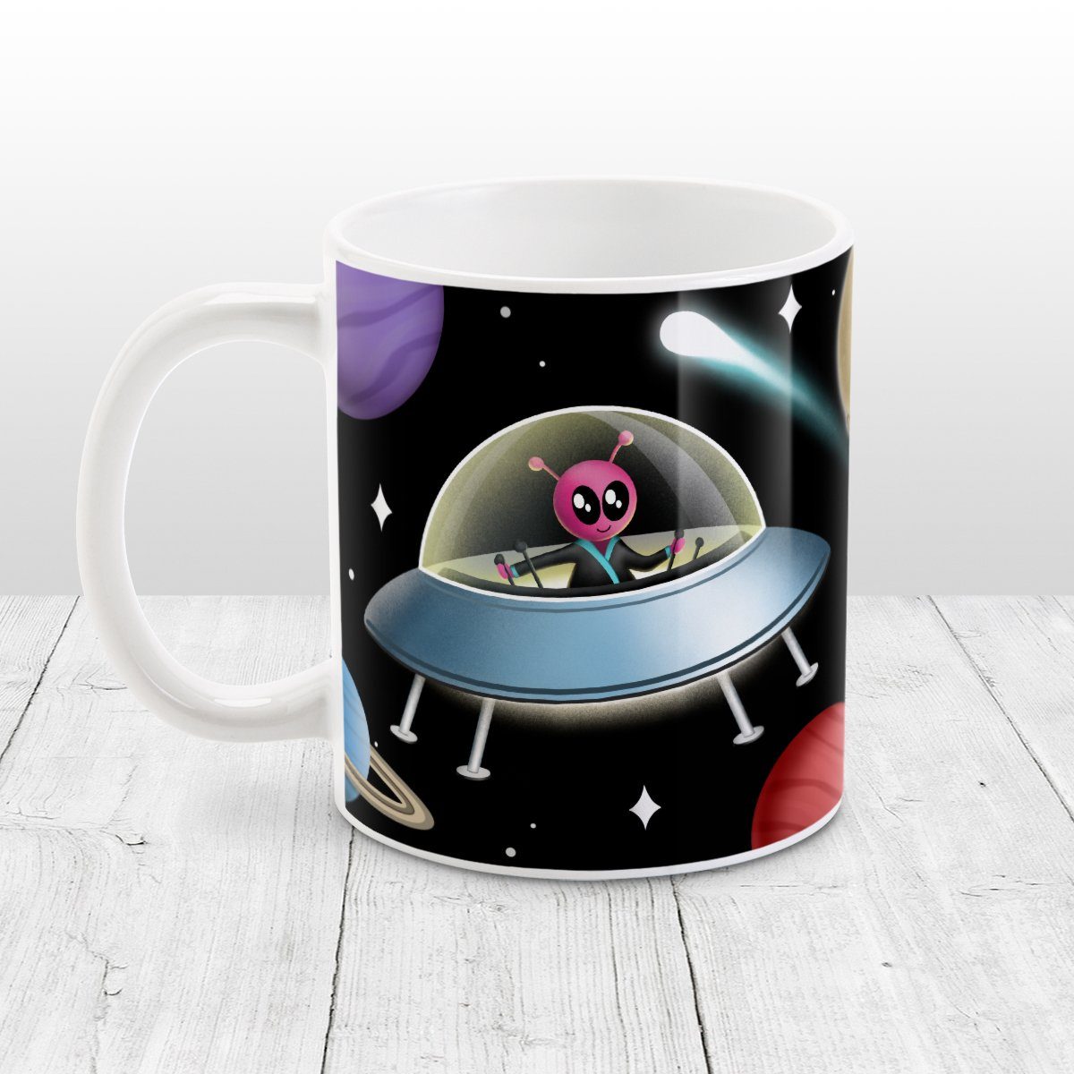 Galaxy Pink Alien Spaceship Mug at Amy's Coffee Mugs. A galaxy spaceship mug designed with an illustration of a pink alien in a spaceship in a galaxy design with planets, stars, comets, and a moon over a black background.