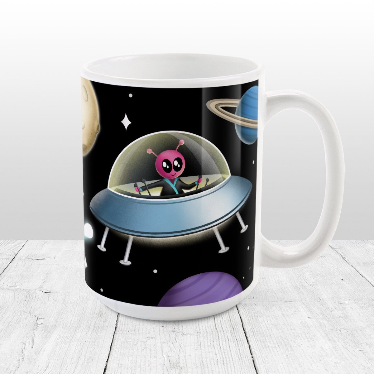 Galaxy Pink Alien Spaceship Mug at Amy's Coffee Mugs. A galaxy spaceship mug designed with an illustration of a pink alien in a spaceship in a galaxy design with planets, stars, comets, and a moon over a black background.