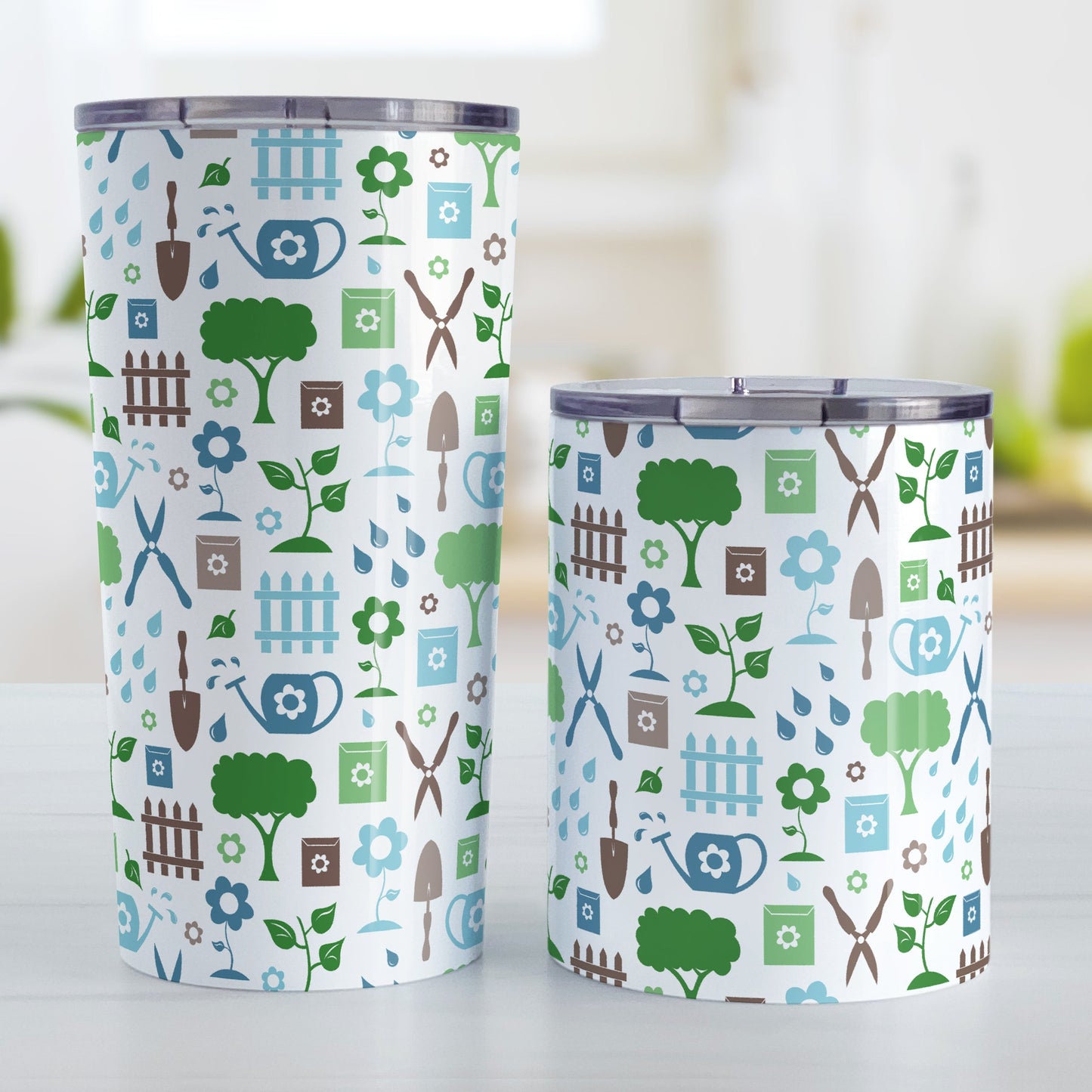 Gardening Pattern Tumbler Cup (20oz and 10oz) at Amy's Coffee Mugs. Stainless steel insulated tumbler cups designed with a gardening pattern with trees, plants, flowers, seed packets, watering cans, fences, and gardening tools in blue, green, and brown. Photo shows both sized cups next to each other.