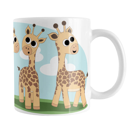 Gathering Giraffes Mug (11oz) at Amy's Coffee Mugs. A ceramic coffee mug designed with five cute illustrated giraffes, with different expressions, around the mug, over a blue sky and green grass background.