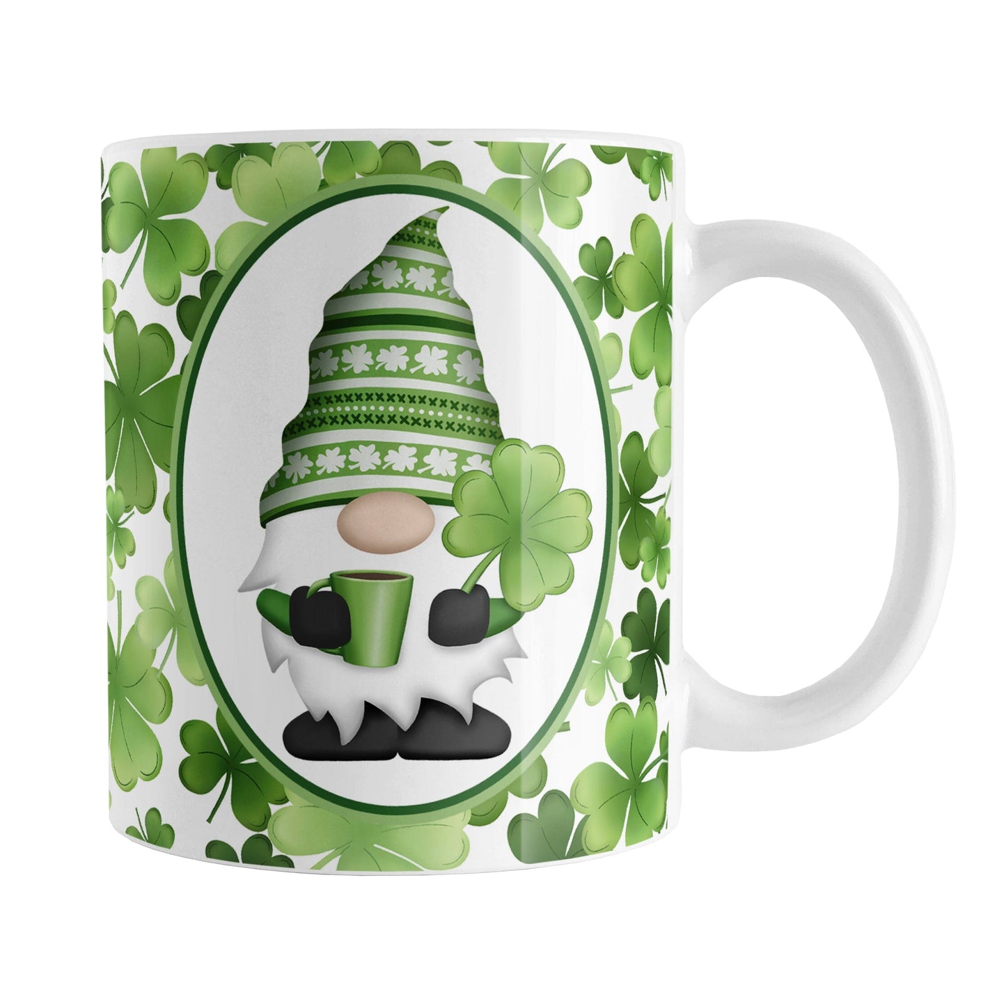 Green Gnome Shamrocks Mug (11oz) at Amy's Coffee Mugs. A ceramic coffee mug designed with an adorable green hat gnome holding a 4-leaf clover and a hot beverage in a white oval over a pattern of green shamrocks in different shades of green that wrap around the mug to the handle.