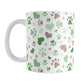 Green Hearts and Paw Prints Mug (11oz) at Amy's Coffee Mugs. A ceramic coffee mug designed with a pattern of hearts and paw prints in brown and different shades of green that wraps around the mug to the handle. This mug is perfect for people love dogs and cute paw print designs.