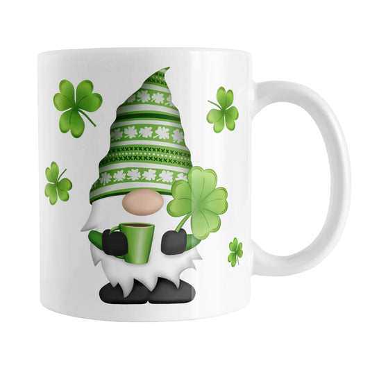 Lucky Clover Gnome Mug (11oz) at Amy's Coffee Mugs. A ceramic coffee mug designed with a gnome with a festive green clover pattern hat, holding a hot beverage and large 4-leaf clover, with shamrocks around the gnome. This cute lucky clover gnome illustration is on both sides of the mug. 