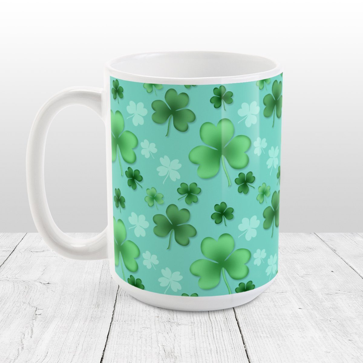 Clover Mug - St Patrick's Day - Lucky Clover Pattern Teal and Green - Clover Mug at Amy's Coffee Mugs. A ceramic coffee mug designed with a lucky green clover pattern with a 4-leaf clover among 3-leaf clovers, in different shades of green, over a teal background that wraps around the mug to the handle.