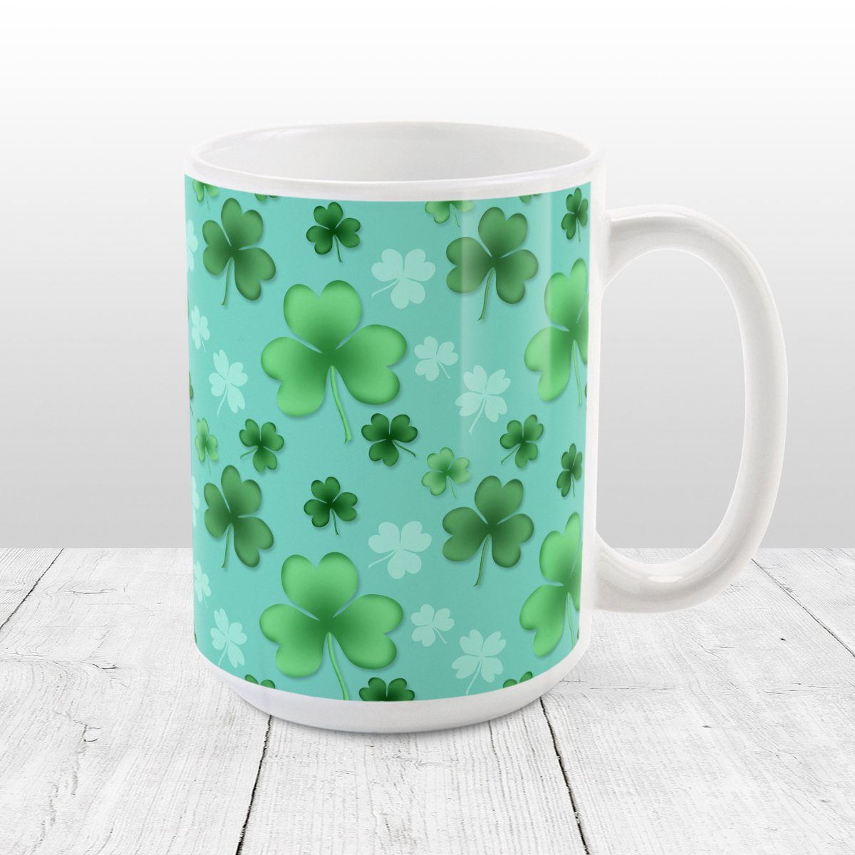 Clover Mug - St Patrick's Day - Lucky Clover Pattern Teal and Green - Clover Mug at Amy's Coffee Mugs. A ceramic coffee mug designed with a lucky green clover pattern with a 4-leaf clover among 3-leaf clovers, in different shades of green, over a teal background that wraps around the mug to the handle.