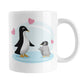 11 oz penguin mug with an adult black-and-white penguin facing a fluffy gray baby penguin, surrounded by pink hearts on a pale blue background design.