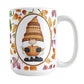 Orange Gnome Fall Leaves Mug (15oz) at Amy's Coffee Mugs. A ceramic coffee mug designed with an adorable orange hat gnome holding an orange pumpkin in a white oval over a pattern of leaves in different fall colors that wrap around the mug to the handle.