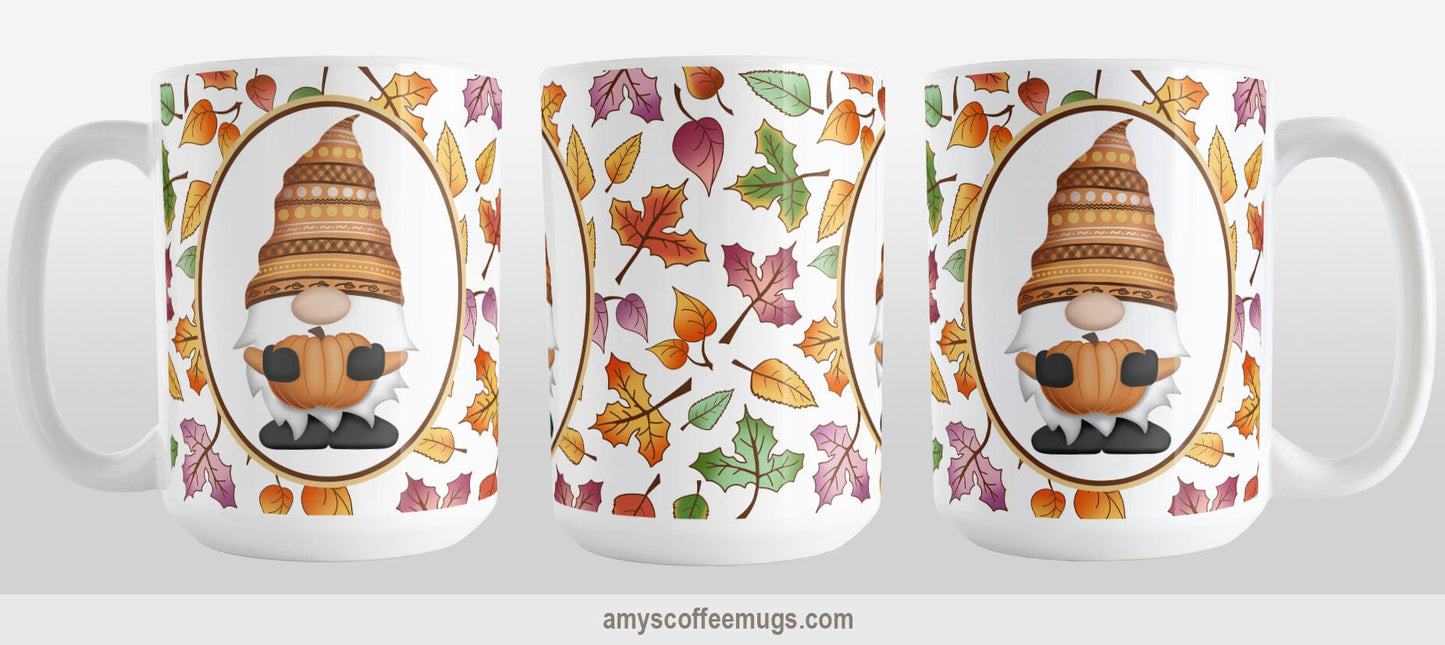 Orange Gnome Fall Leaves Mug (15oz) at Amy's Coffee Mugs. A ceramic coffee mug designed with an adorable orange hat gnome holding an orange pumpkin in a white oval over a pattern of leaves in different fall colors that wrap around the mug to the handle. Photo shows 3 views of the mug to display the entire printed design on the mug.