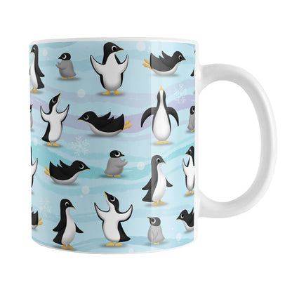 Penguin Parade Pattern Mug (11oz) at Amy's Coffee Mugs. A ceramic coffee mug designed with a fun penguin parade pattern featuring a variety of penguins and baby penguins over an Antarctic background with waves of blue, turquoise, and purple colors with hints of snowflakes that wraps around the mug.
