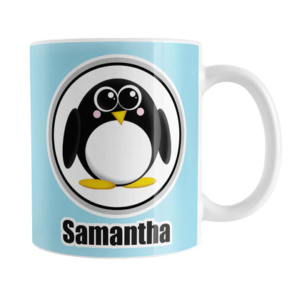Personalized Adorable Light Blue Penguin Mug (11oz) at Amy's Coffee Mugs. A ceramic coffee mug designed with an adorable rounded penguin in a white circle over a light blue background that wraps around the mug to the handle. Your name is personalized in black below the penguin, on both sides of the mug. 