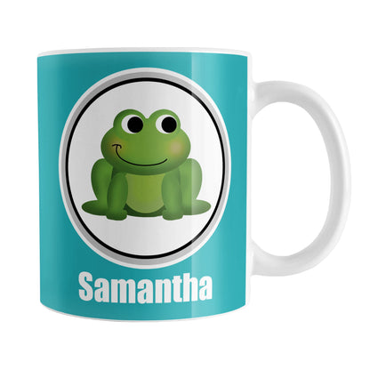 Personalized Adorable Turquoise Frog Mug (11oz) at Amy's Coffee Mugs. A ceramic coffee mug designed with a cute and happy green frog in a white circle on both sides of the mug over a turquoise background color that wraps around the mug up to the handle. Your name is custom-printed in white below the adorable frog.