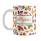 Personalized Changing Leaves Fall Mug (11oz) at Amy's Coffee Mugs. A ceramic coffee mug designed with a fall themed pattern of leaves changing colors, as they do at the beginning of autumn, that wraps around the mug. Your personalized name is custom printed in an orange script font on both sides of the mug over the leaves pattern.