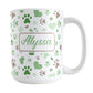 Personalized Green Hearts and Paw Prints Mug (15oz) at Amy's Coffee Mugs. A ceramic coffee mug designed with a pattern of hearts and paw prints in green and brown that wraps around the mug to the handle. Your name is personalized in green on both sides of the mug.