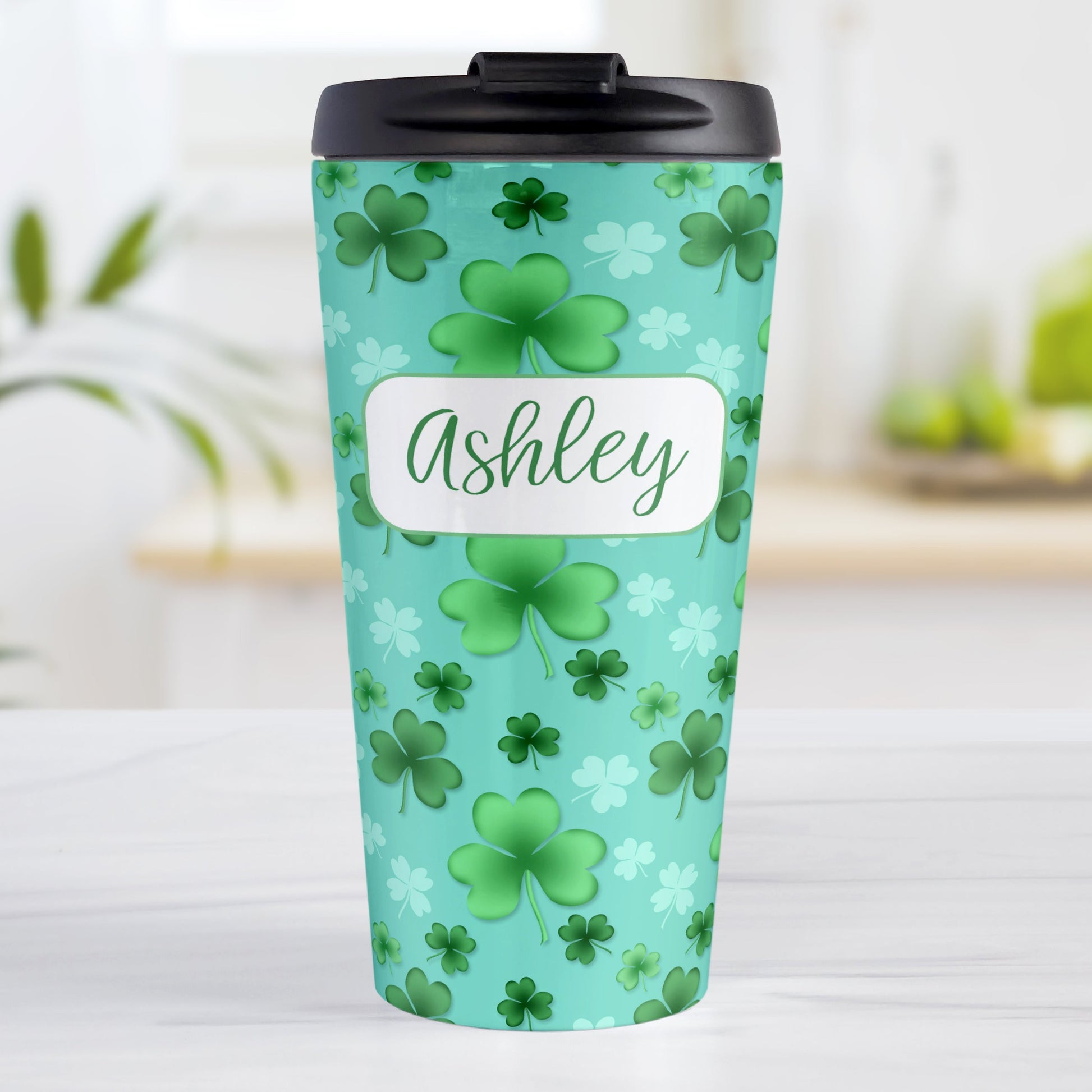 Personalized Lucky Clover Pattern Teal and Green Travel Mug (15oz, stainless steel insulated) at Amy's Coffee Mugs. A travel mug designed with a lucky green clover pattern with a 4-leaf clover among 3-leaf clovers, in different shades of green, over a teal background that wraps around the mug. Your name is personalized in green on white, over the lucky clover pattern.