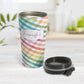 Personalized Rainbow Gingham Travel Mug at Amy's Coffee Mugs. A travel mug designed with a slanted gingham pattern with a colorful rainbow progression that wraps around the travel mug. Your personalized name is printed in a pretty purple script font in a white frame design over the rainbow gingham pattern. Photo shows the mug open on a table with its lid beside it.