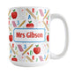 Personalized School Pattern Mug (15oz) at Amy's Coffee Mugs. A ceramic coffee mug designed with a school-themed pattern with apples, rulers, erasers, graded papers, numbers, and letters that wraps around the mug to the handle. Your personalized name or your teacher's name is custom printed on both sides of the mug over the school pattern.