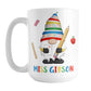 Personalized School Teacher Gnome Mug (15oz) at Amy's Coffee Mugs. A ceramic coffee mug designed with an illustration of an adorable gnome wearing a festive hat with numbers and letters in primary colors and holding a large oversized pencil and graded A+ paper. Around the gnome are an eraser, a ruler, and a red apple. Your personalized name or your teacher's name is custom printed below the gnome in blue, red, yellow, and green alternating colored letters.
