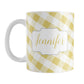 Personalized Yellow Gingham Mug (11oz) at Amy's Coffee Mugs. A ceramic coffee mug designed with a slanted yellow and white gingham pattern that wraps around the mug up to the handle. Your personalized name is custom-printed in a yellow script font on both sides of the mug over the gingham pattern.