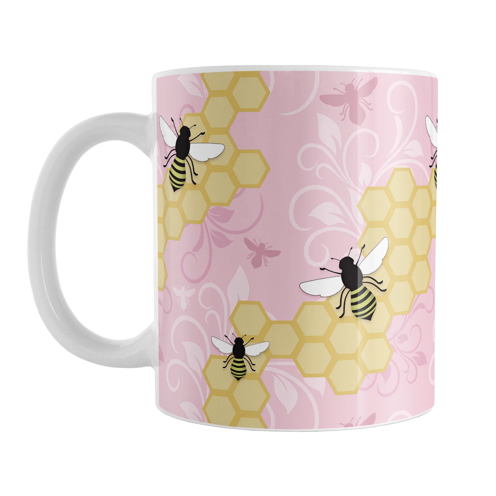 Pink Honeycomb Bee Mug (11oz) at Amy's Coffee Mugs. A ceramic coffee mug designed with a pattern of black and yellow bees on honeycomb lines over a pink flourish background that wraps around the mug to the handle.