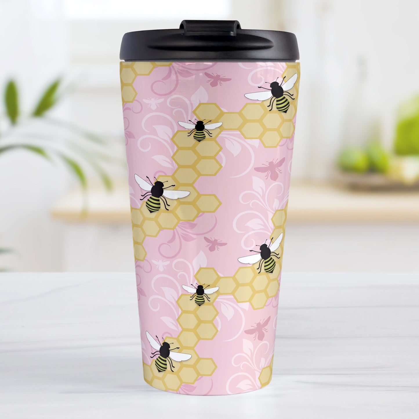 Pink Honeycomb Bee Travel Mug (15oz, stainless steel insulated) at Amy's Coffee Mugs. A travel mug designed with a pattern of black and yellow bees on honeycomb lines over a pink flourish background that wraps around the tapered shaped mug.