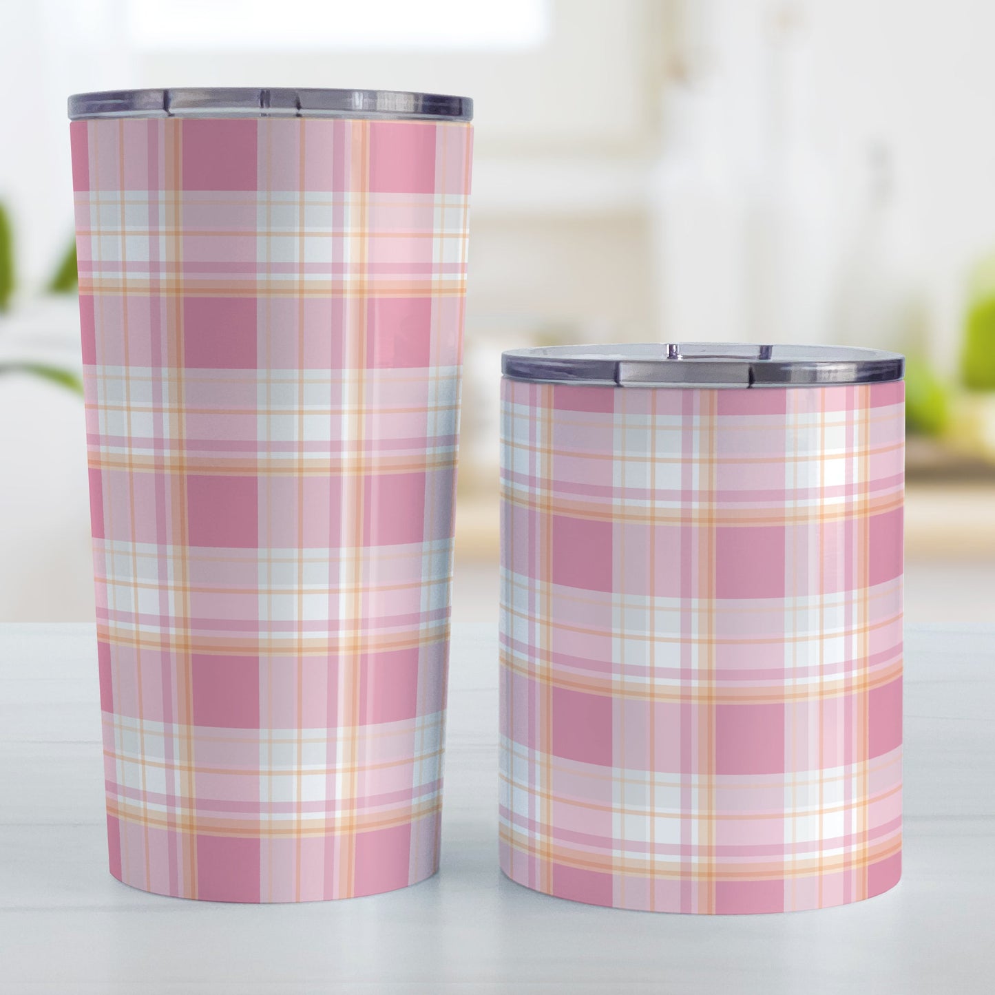 Pink Orange Plaid Tumbler Cup (20oz and 10oz) at Amy's Coffee Mugs. Stainless steel insulated tumbler cup designed with a pink plaid pattern with orange accents that wraps around the cups. Preppy and stylish cups for people who love pink and orange colors together. Photo shows both sized cups next to each other.