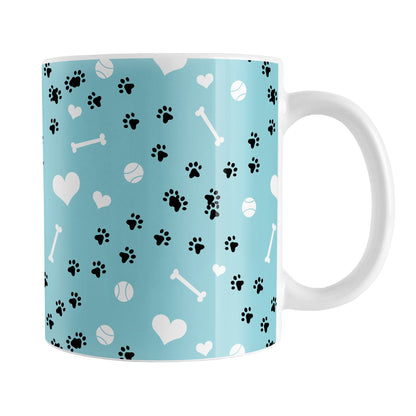 Puppy Run Blue Dog Mug (11oz) at Amy's Coffee Mugs. A ceramic coffee mug designed with a pattern of chaotic tracks of puppy paw prints running around the mug with white dog bones, balls, and hearts over a light blue background. This mug is perfect for people who love the chaotic play of puppies, love dogs, and like blue mugs. 