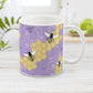Purple Honeycomb Bee Mug at Amy's Coffee Mugs. A ceramic coffee mug designed with a pattern of black and yellow bees on honeycomb lines over a purple flourish background that wraps around the mug to the handle.