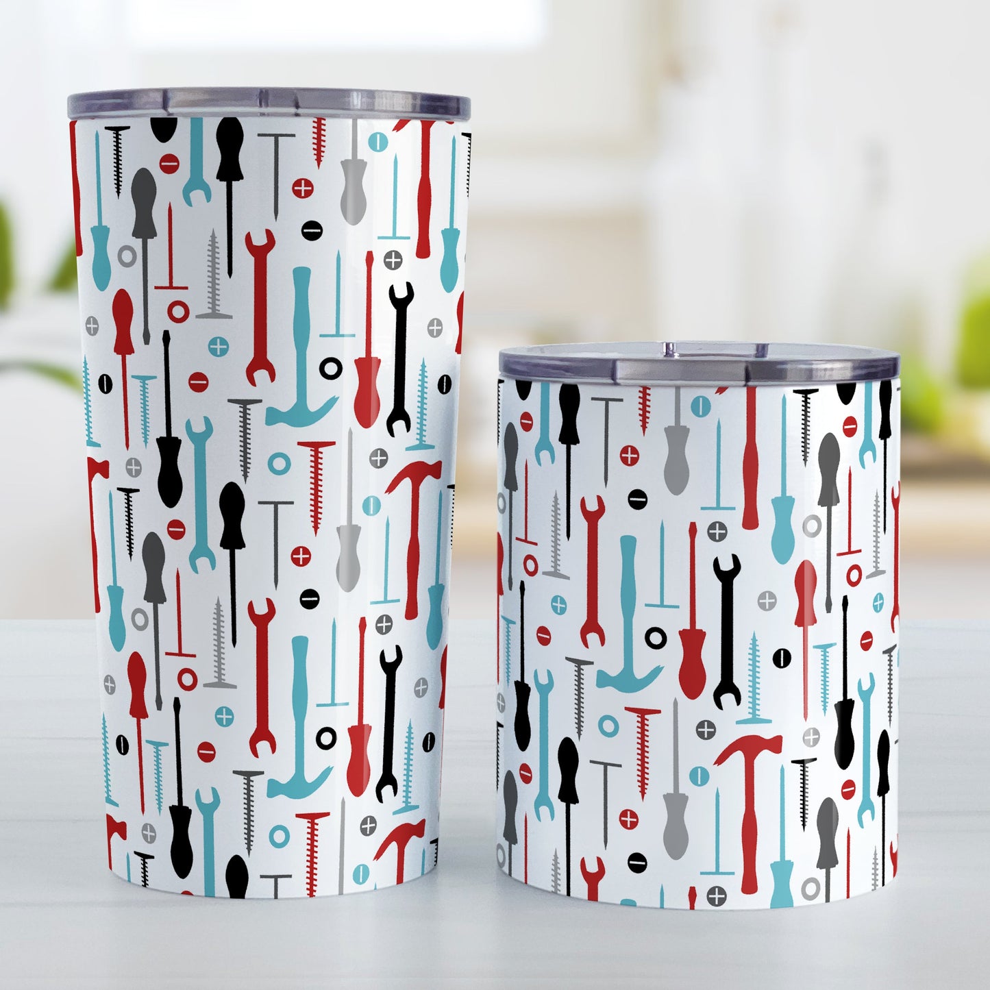 Red Turquoise Tools Pattern Tumbler Cup (20oz and 10oz, stainless steel insulated) at Amy's Coffee Mugs. Tumbler cups with a modern style pattern of tools in red, turquoise, black, and gray over white that wraps around the cups. Perfect for any handyman or contractor. Photo shows both sized cups next to each other.