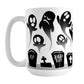 Rising Ghosts Halloween Mug (15oz) at Amy's Coffee Mugs.A ceramic coffee mug featuring whimsical ghosts rising above cemetery gravestones in a black and white design that wraps around the mug up to the handle. 