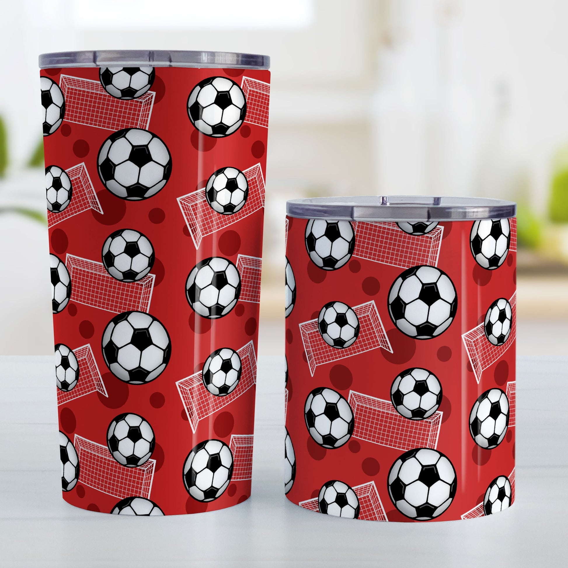 Soccer Ball and Goal Pattern Red Tumbler Cup (20oz and 10oz) at Amy's Coffee Mugs. Stainless steel insulated tumbler cups designed with a pattern of soccer balls and goals over a red background that wraps around the cups. These red soccer tumbler cups are perfect for people who love or play soccer. Photo shows both sized cups next to each other.