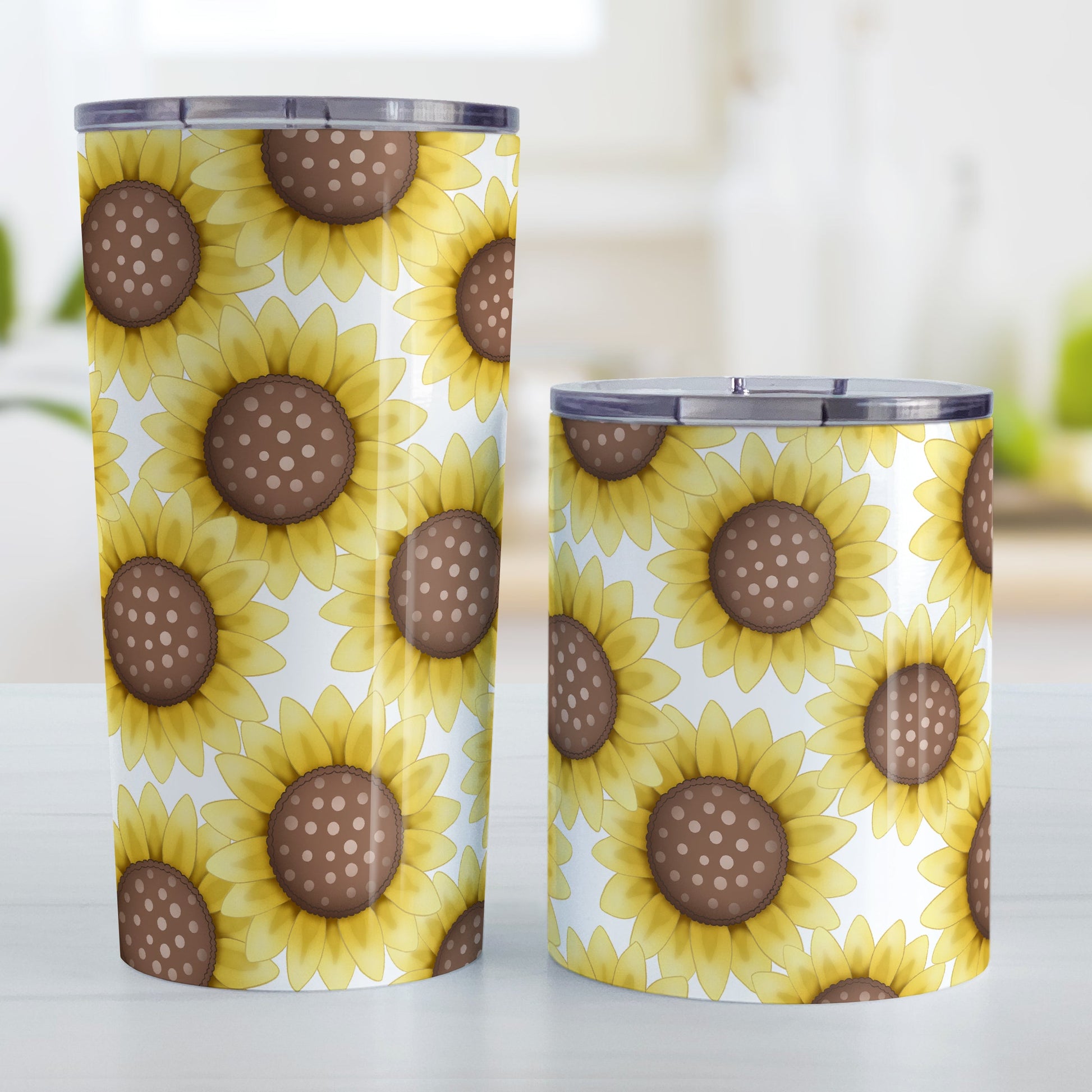 Sunflower Pattern Tumbler Cup (20oz and 10oz) at Amy's Coffee Mugs. Stainless steel insulated tumbler cups designed with cute yellow sunflowers with dotted brown centers in a pattern that wraps around the cups. Photo shows both sized cups next to each other.