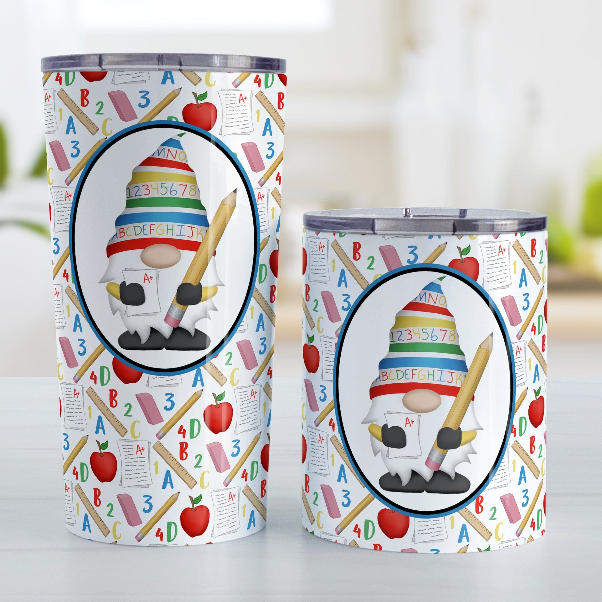 Teacher Gnome School Pattern Tumbler Cups (20oz or 10oz) at Amy's Coffee Mugs. Stainless steel tumbler cups designed with an illustration of an adorable gnome wearing a festive hat with numbers and letters in primary colors and holding a large oversized pencil and graded A+ paper inside an oval. This cute gnome oval is placed over a school-themed pattern that wraps around the cups with apples, rulers, erasers, graded papers, numbers, and letters.