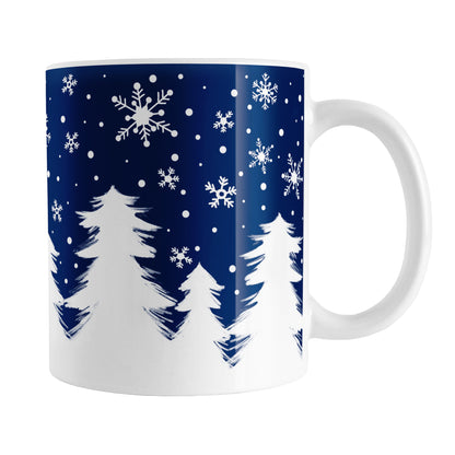 Winter Night Snow Mug (11oz) at Amy's Coffee Mugs. A ceramic coffee mug designed with an illustrated winter night snow treeline. The design features a navy blue sky is filled with white snowflakes over a row of white pine trees along the bottom.
