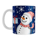 Winter Snowman Mug (11oz) at Amy's Coffee Mugs. A ceramic coffee mug designed with an illustration of a happy snowman wearing a red scarf and hat, while holding a blue gift box, over a winter night sky background with snowflakes around him.