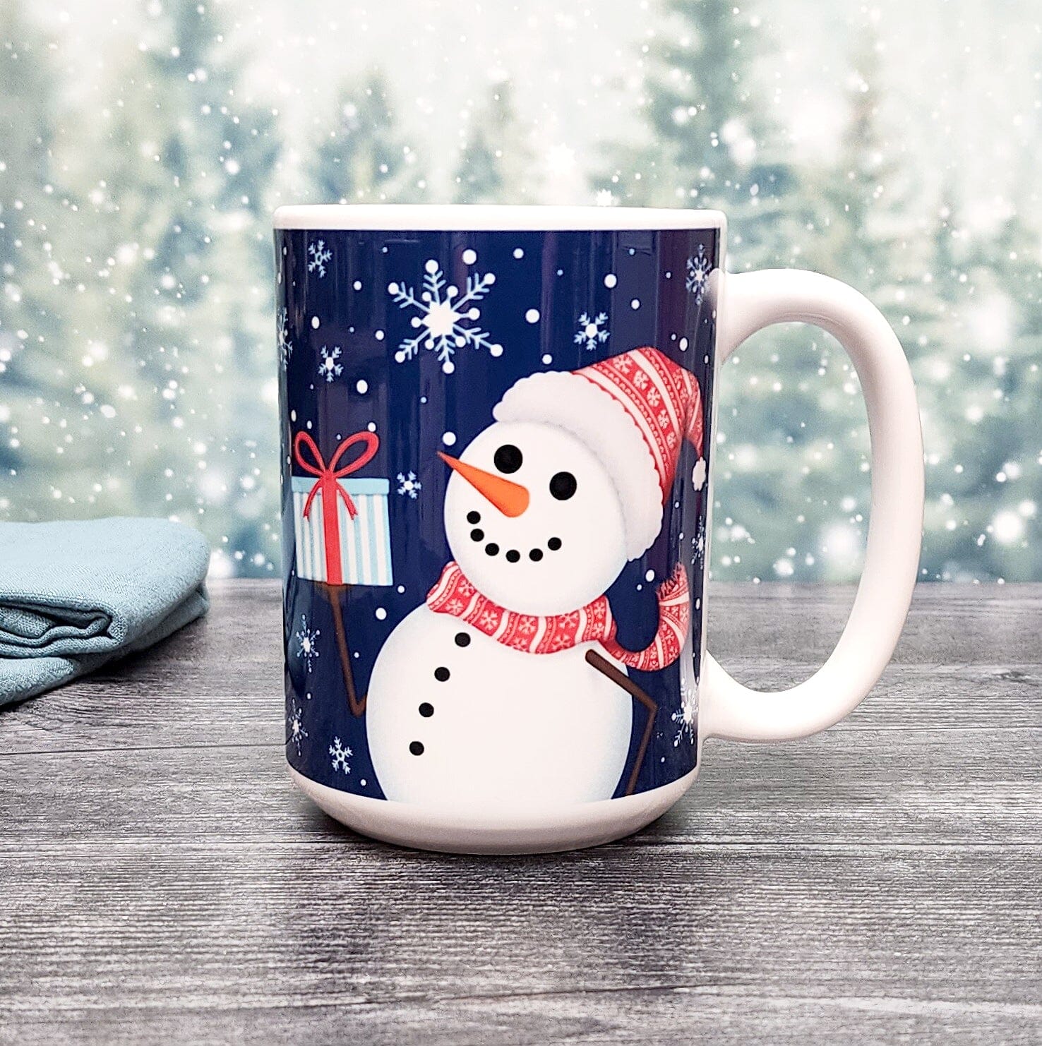 Winter Snowman Mug (15oz) on a festive snowy tree background, from Amy's Coffee Mugs