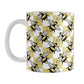 Yellow Checkered Bee Mug (11oz) at Amy's Coffee Mugs. A ceramic coffee mug designed with a an alternating pattern of black and yellow bees spaced evenly on the corners of a yellow and white checkered pattern that wraps around the mug up to the handle.