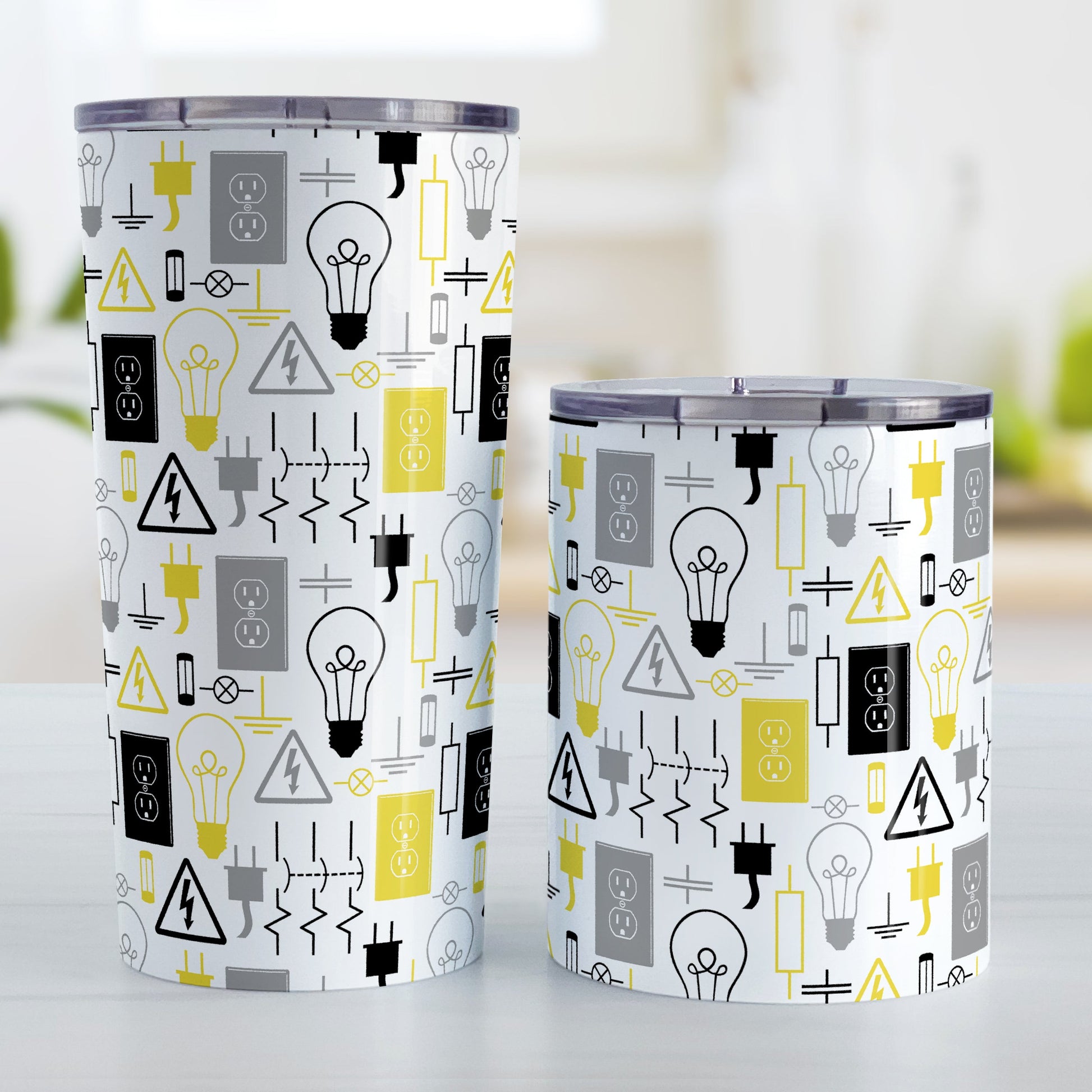 Yellow Electrical Electrician Tumbler Cup (20oz and 10oz) at Amy's Coffee Mugs. Stainless steel insulated tumbler cups designed with an electrical pattern with light bulbs, wall sockets, plugs, fuses, and other electricity symbols in yellow, gray, and black colors that wraps around the cups. These cups are perfect for people who work a trade as an electrician, love working with electronics, and working in electrical engineering. Photo shows both sized cups next to each other.